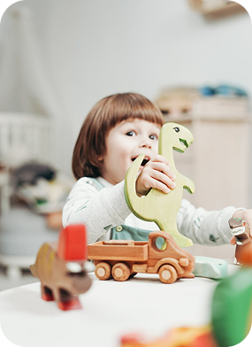 Child playing with dinosaur toy